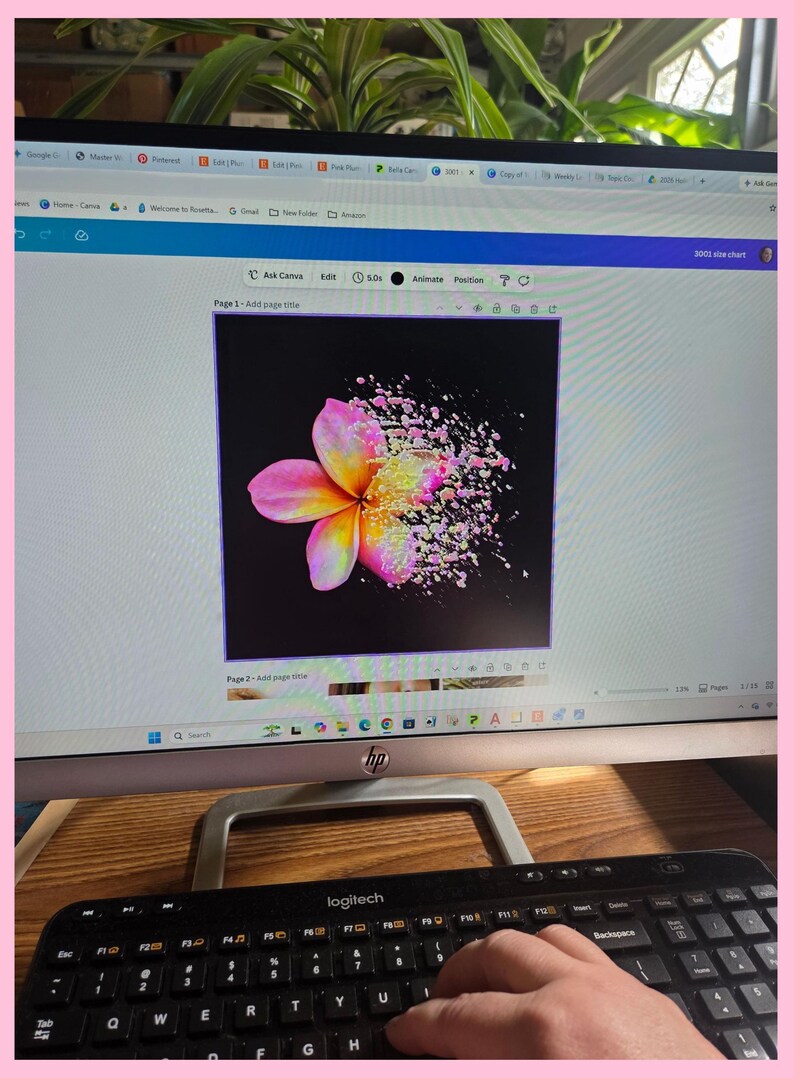 May include: A computer monitor displaying a digital graphic design software interface. The screen shows a vibrant plumeria flower on a black background, with the right side of the flower petals appearing to dissolve into small, colorful particles.