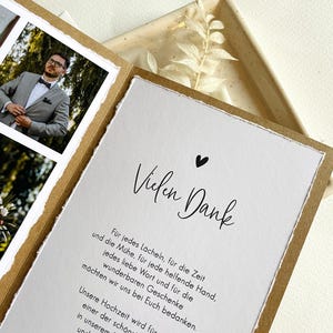 May include: A thank you card with a handwritten message in black ink on a white background. The card has a brown border and a small black heart in the top right corner. The text reads "Vielen Dank" and includes a message of gratitude for the recipient's support.