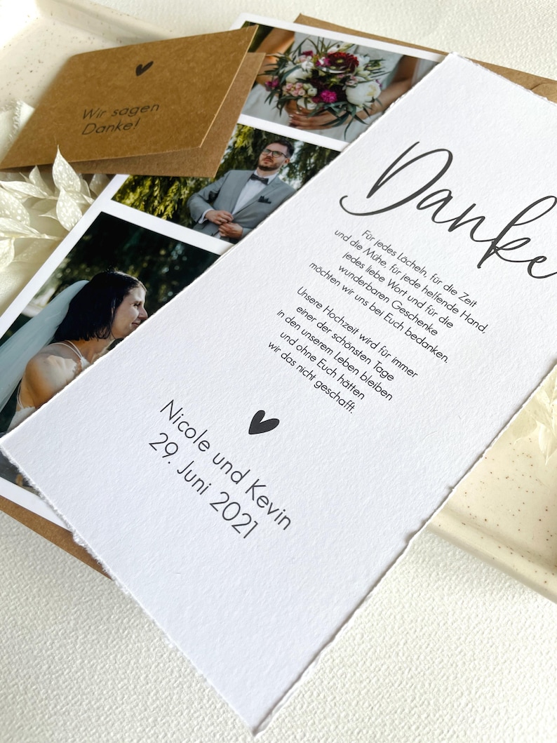 May include: A white card with a handwritten thank you message in black ink. The card has a small heart symbol and the text "Nicole and Kevin 29. June 2021".