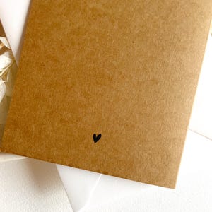 May include: A brown card with a small black heart in the bottom right corner.