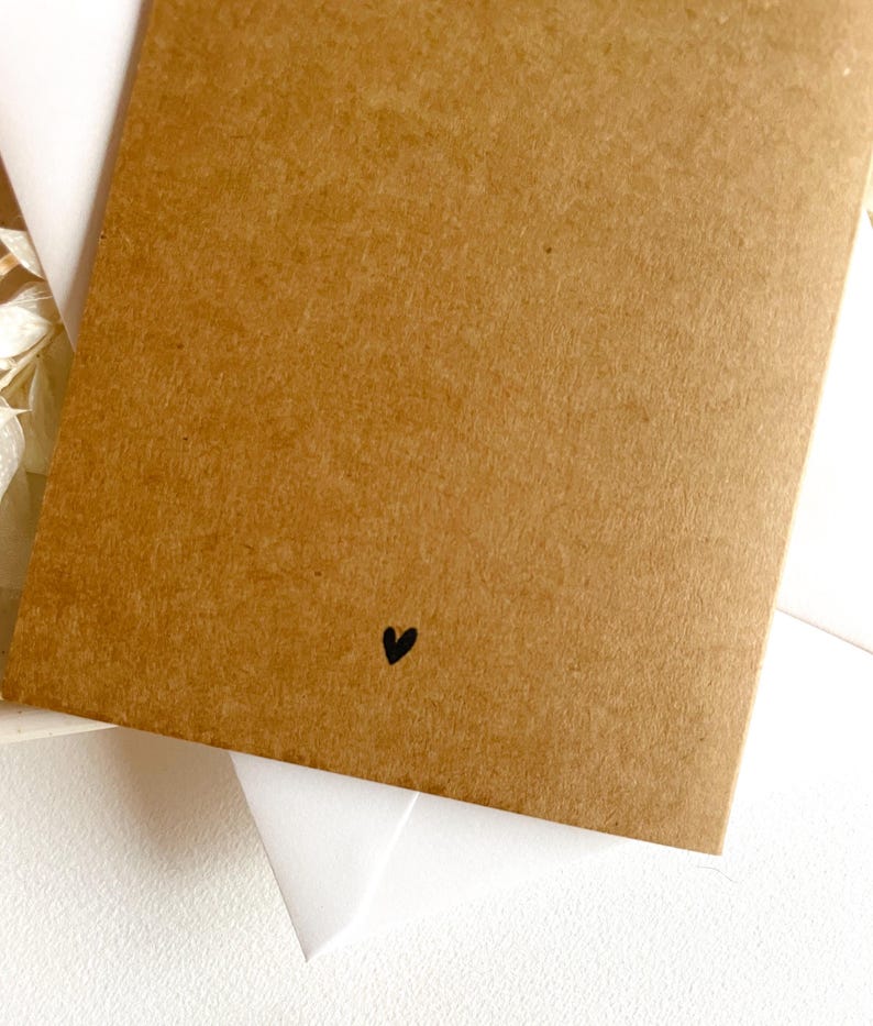 May include: A brown card with a small black heart in the bottom right corner.