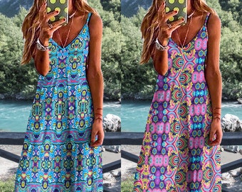 May include: Two women wearing sleeveless maxi dresses with colorful geometric patterns. The dress on the left is blue with pink, yellow, and green accents. The dress on the right is purple with pink, yellow, and green accents.