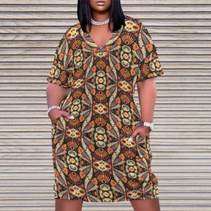 May include: A short-sleeved dress with a V-neck and a colorful geometric pattern. The dress has pockets on both sides.