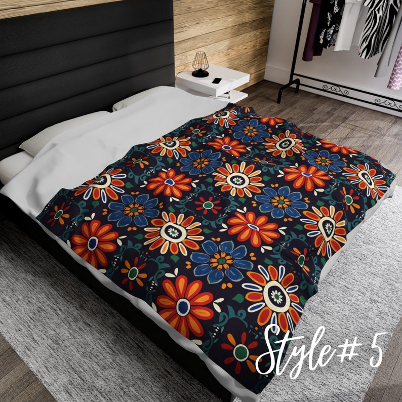 May include: A dark blue bedspread with a floral pattern featuring orange, red, blue, and green flowers. The bedspread has a repeating pattern of stylized flowers with a white center. The text "Style #5" is visible in the lower right corner of the image.