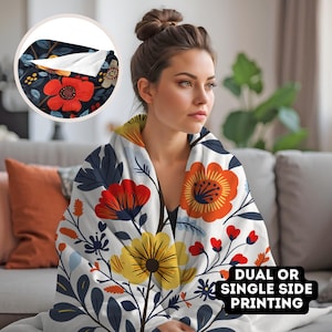 May include: A woman wearing a white, blue, and orange floral patterned throw blanket. The blanket has a dual or single side printing option.