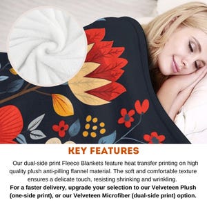 May include: A soft, plush fleece blanket with a floral pattern in shades of red, yellow, and blue on a dark blue background. The blanket is shown folded and draped over a bed with a person sleeping on it. The text "KEY FEATURES" is visible at the bottom of the image.