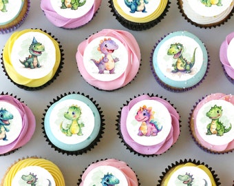 May include: Twelve cupcakes decorated with round edible images of cartoon dinosaurs. The dinosaurs are in various colors, including green, blue, purple, and orange. The cupcakes are arranged in a circle on a white surface.