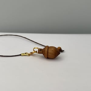 Handmade olive wood dowsing pendulum, sold with its box and carrying bag