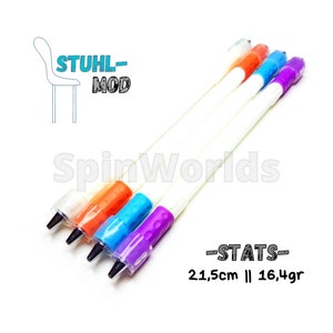 May include: Four white pens with different colored tips: orange, blue, purple, and white. The pens are 21.5 cm long and weigh 16.4 grams. The text "STUHL-MOD" is in the upper left corner of the image. The text "SpinWorlds" is in the lower left corner of the image. The text "STATS" is in the lower right corner of the image. The text "21,5cm || 16,4gr" is below the text "STATS".