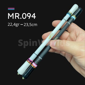 May include: Two fishing rods, one white and one black, with gold lettering and a pink and blue accent ring. The rods are 22.4 grams and 23.5 centimetres long. MR.094.