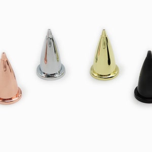 May include: Four pen nibs in different colors: rose gold, silver, gold, and black.