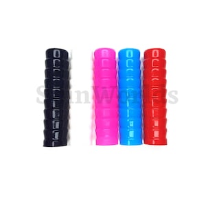 May include: A collection of four colorful, ribbed handles. The handles are black, pink, blue, and red. Each handle has a cylindrical shape with a series of horizontal ridges. The handles are arranged vertically against a white background.