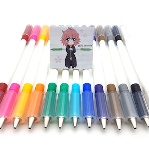 May include: A set of 15 colorful refillable pens with white barrels and clear ink reservoirs. The pens are arranged in a row on a white surface. The ink colors include red, pink, yellow, orange, green, blue, purple, brown, gray, and black.