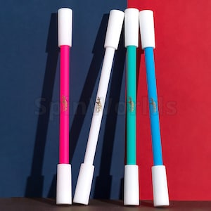 May include: Four white-capped, colourful markers with gold lettering. The markers are pink, white, teal, and blue. The markers are arranged in a row on a surface.