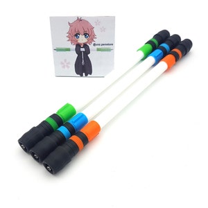 May include: Three white pens with black caps and colored accents. The pens have green, blue, and orange accents.