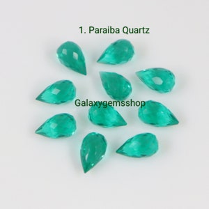 Może przedstawiać: Dziesięć fasetowanych, zielonych kamieni szlachetnych w kształcie łzy. Kamienie szlachetne są oznaczone jako "1. Paraiba Quartz" i "Galaxygemsshop".