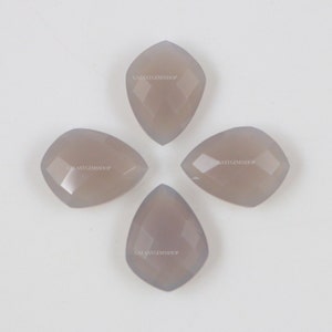 May include: Four gray gemstone cabochons in a pear shape with faceted edges. The stones are arranged in a cross pattern.