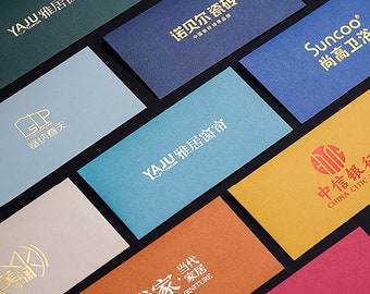 May include: A collection of business cards with various company logos and names, including YAJU, Suncoo, and China CITIC. The cards are printed on different colored paper with a textured finish.