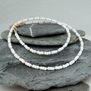 White seed bead necklace with silver or gold highlighting beads in lengths from 14" to 24"