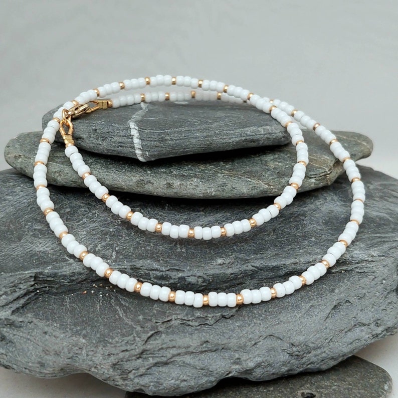 White seed bead necklace with silver or gold highlighting beads in lengths from 14" to 24"
