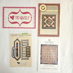 May include: Four quilting patterns are displayed. One has the text "TO QUILT" with a heart design. Another is labeled "Merry Medley" with a floral design. The third is "Double Duty Runners". The last is "Heartfelt Garden".