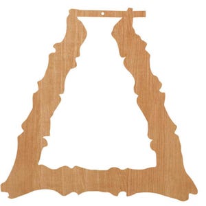 May include: A wooden decorative cutout in the shape of a stylized mountain range. The cutout is light brown with a natural wood grain pattern. It has a hole at the top for hanging.