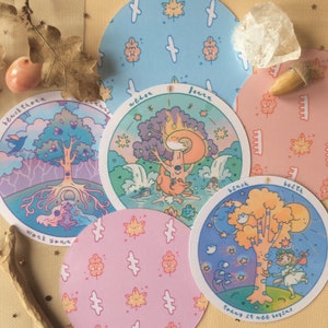May include: A selection of circular art prints with charming illustrations of trees, animals, and natural settings. The prints are in pastel shades, with text around the edges. Some prints feature leaf patterns.