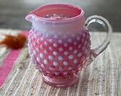 Luxurious Coconut Soy Wax Blend Featuring Raspberry Chamomile Fragrance and Wooden Wick in Cranberry Opalescent Hobnail Pitcher
