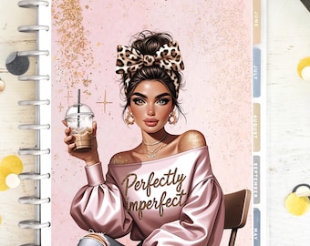 May include: A planner cover featuring a fashion illustration of a woman with a leopard print bow, holding an iced coffee. The woman wears a pink off-the-shoulder top with the text "Perfectly imperfect". The planner has monthly tabs.