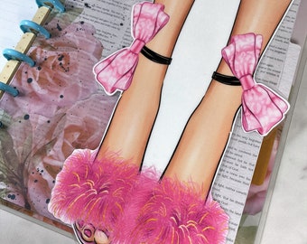 May include: A pair of pink fuzzy slippers with gold accents and pink bows on the ankles. The slippers are on a white background.