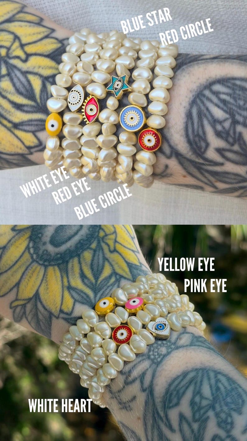 May include: Pearl bracelets with decorative charms. The charms include a blue star, red circle, white eye, red eye, blue circle, yellow eye, pink eye, and white heart. The bracelets are worn on the wrist.