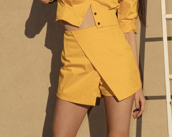 Minifalda asimétrica de algodón con pantalones cortos: cintura alta cruzada