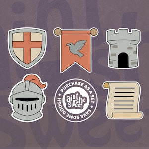 May include: Set of six medieval-themed cookie cutters. Includes a shield with a cross, a banner with a dove, a castle tower, a knight's helmet, a scroll, and a circular logo that says "Purchase as a set, save some dough".
