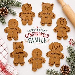 May include: Seven gingerbread cookies shaped like people and animals, each with a name engraved on the chest. The text in the center reads BUILD YOUR OWN GINGERBREAD FAMILY. The cookies are arranged around the text with pine branches and a rolling pin.