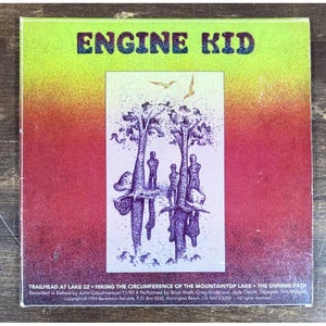 May include: A CD case with the band name "ENGINE KID" in a green and yellow gradient. The cover art features a purple illustration of trees and figures. The bottom text includes song titles and recording information.