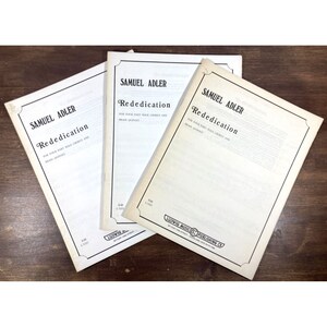 May include: Three sheet music books titled "Rededication" by Samuel Adler. The covers are white with black text and a decorative border. The books are for four-part male choruses and brass quintet.