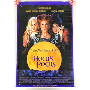 May include: A movie poster for "Hocus Pocus" featuring Bette Midler, Sarah Jessica Parker, and Kathy Najimy. The poster has a dark blue background with the film's title in gold over a yellow moon. The text "Very, Very Funny, A 10!" is also visible.