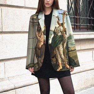 May include: A structured blazer featuring a full-colour classical painting print with figures in historical attire, worn over a plain black mini dress, black opaque tights, and black lace-up combat boots with thick soles and visible yellow stitching.