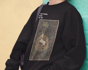 May include: A black sweatshirt with a graphic print of a white unicorn in a circular mosaic design. The text "When I'm Happy" is printed above the graphic and "I Dance" is printed below the graphic.