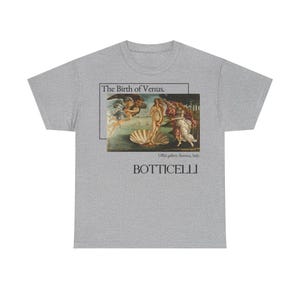 May include: A heather gray t-shirt featuring Botticelli's "The Birth of Venus" artwork. The design includes the painting, the text "The Birth of Venus," and the artist's name, "Botticelli."