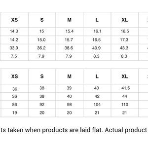 May include: A white t-shirt graphic with a size chart showing measurements in inches and centimetres. The chart includes measurements for length, shoulder, bust, and sleeve for sizes XS to 5XL. The text at the bottom states that measurements may vary by up to 2.5 cm.