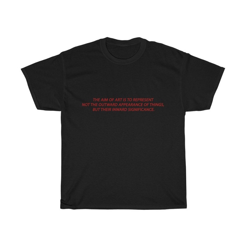May include: Black t-shirt with the red text: "THE AIM OF ART IS TO REPRESENT NOT THE OUTWARD APPEARANCE OF THINGS, BUT THEIR INWARD SIGNIFICANCE." The shirt is a classic crew neck style, made of a soft material.