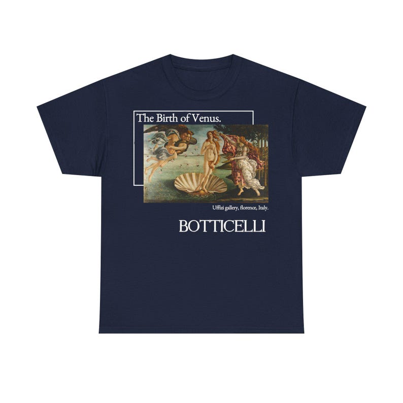May include: Navy blue t-shirt featuring Botticelli's "The Birth of Venus" artwork. The design includes the painting within a white frame, with the text "The Birth of Venus" above and "Botticelli" below. The shirt is a classic crew neck.