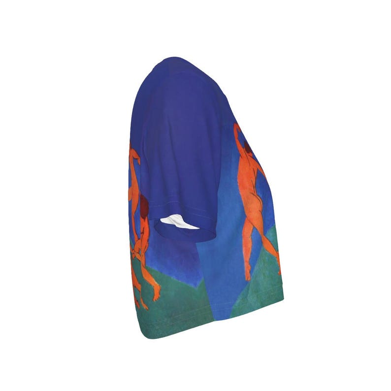 May include: A blue short-sleeved shirt with a print of orange figures set against blue and green shapes. The design is a stylized representation of human forms, giving a sense of movement. The artwork is reminiscent of a painting.