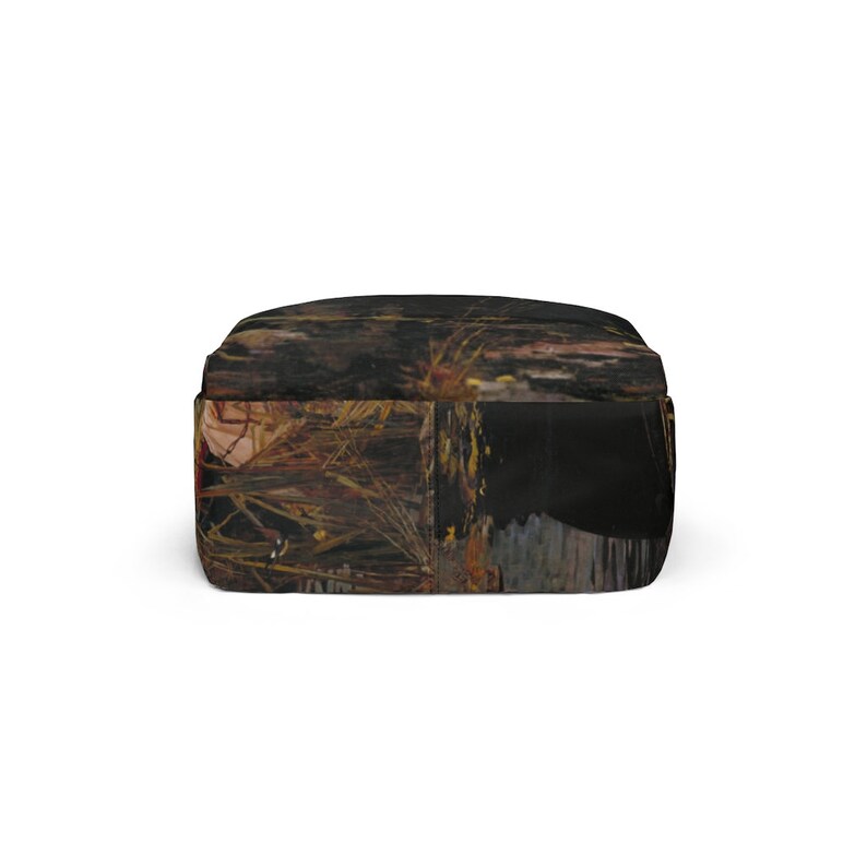 May include: A black backpack with a camouflage pattern featuring shades of brown, gold, and red. The pattern resembles a forest scene with leaves and branches.