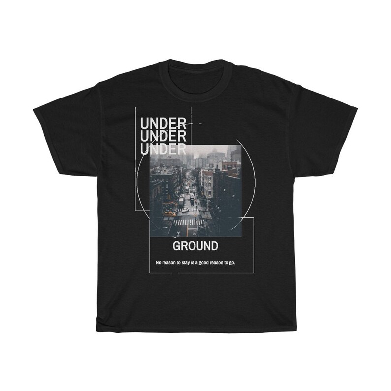 May include: Black t-shirt with a graphic design featuring a city street scene. The design includes the words "UNDER" stacked three times, "GROUND", and the phrase "No reason to stay is a good reason to go."
