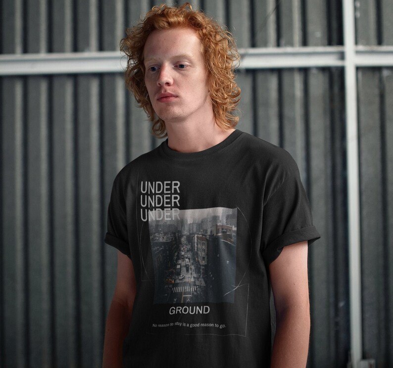 May include: Black t-shirt with the words "UNDER UNDER UNDER" stacked vertically above a cityscape image and the word "GROUND" below. The shirt also has the text "No reason to stay is a good reason to go."