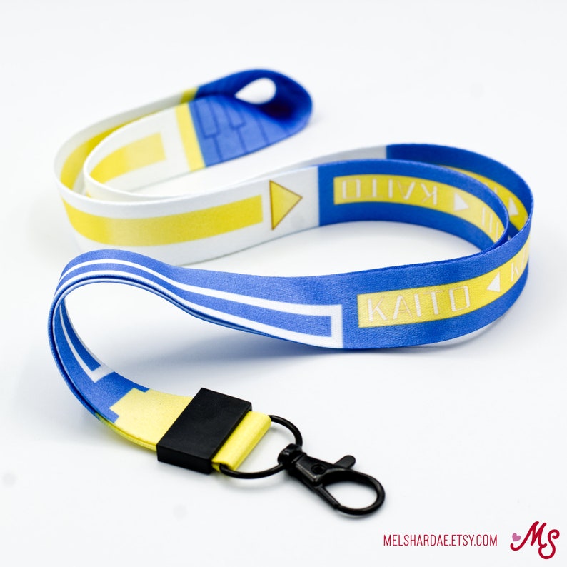 May include: A blue and yellow lanyard with the text "KAITO" and "DIV" printed on it. The lanyard has a black clip on one end.