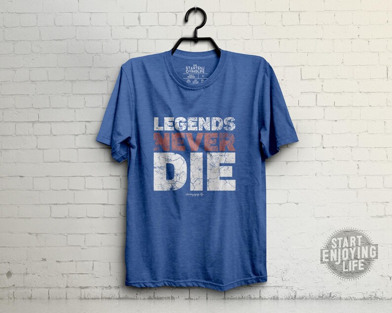 May include: A blue t-shirt with the text "Legends Never Die" in white with red accents. The text has a distressed look.