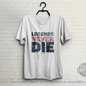 May include: White t-shirt with a blue and red distressed graphic that says "Legends Never Die".